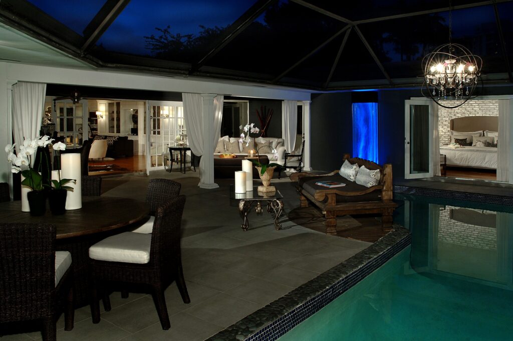 Pool entry at dusk with glowing interior and water reflections